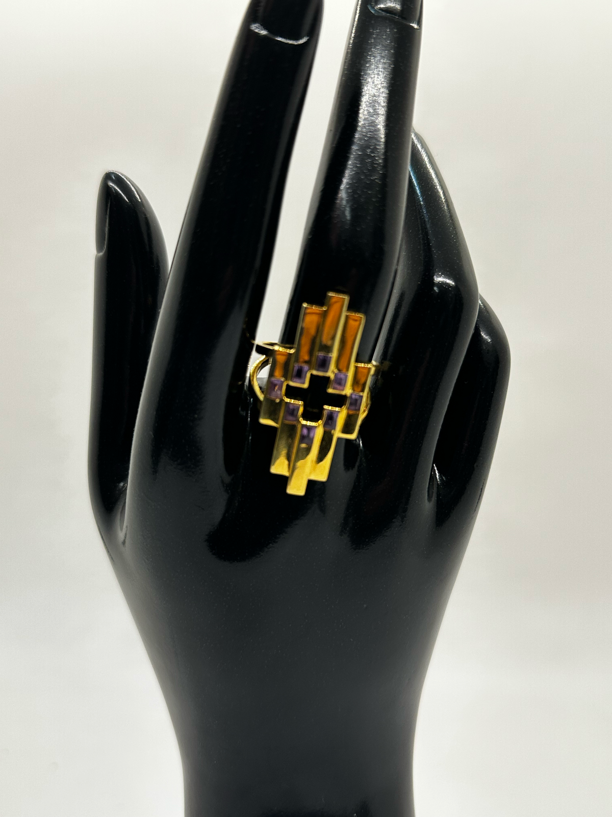 Black handbag with gold logo on a white background