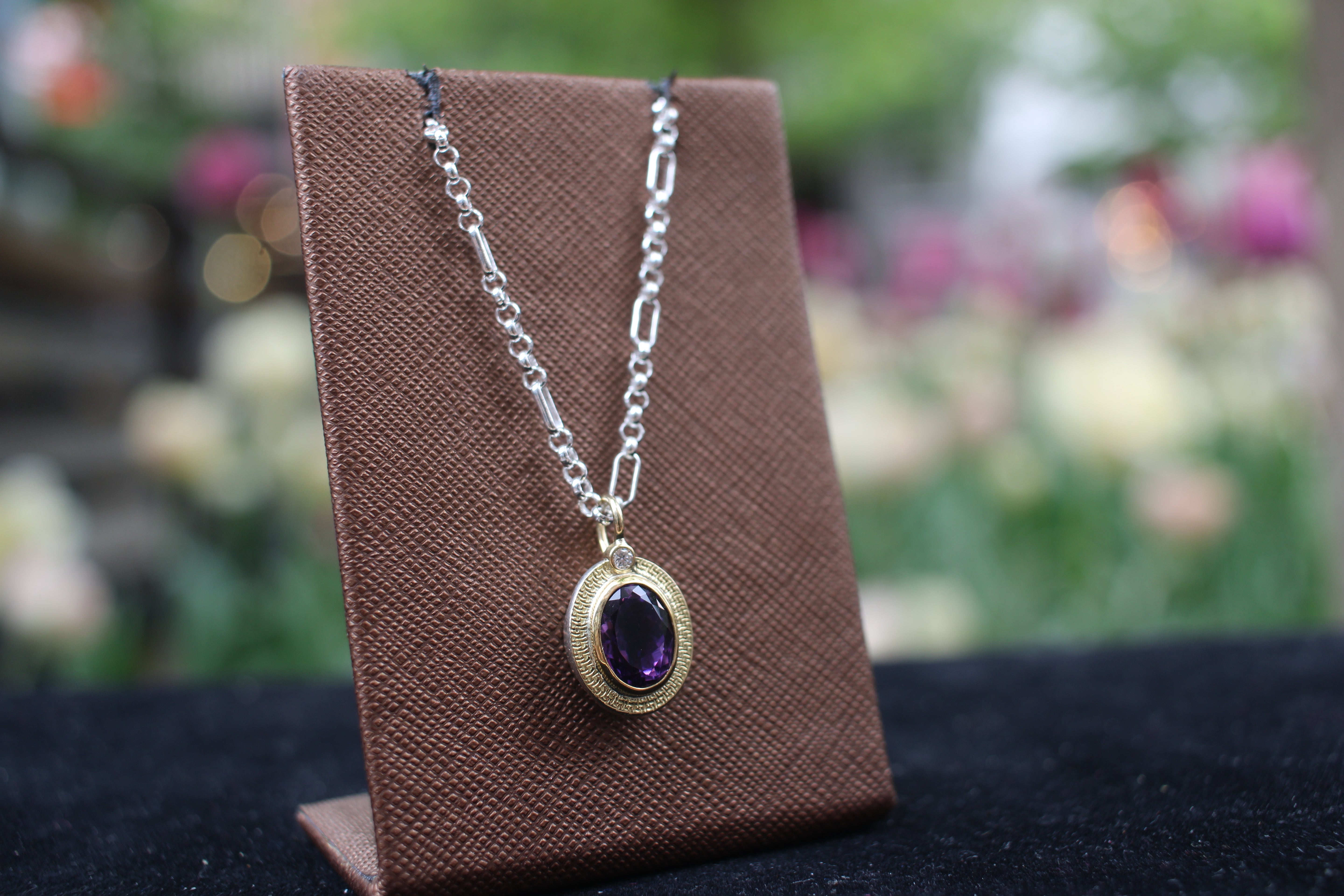 Amethyst and diamond set in gold pendant